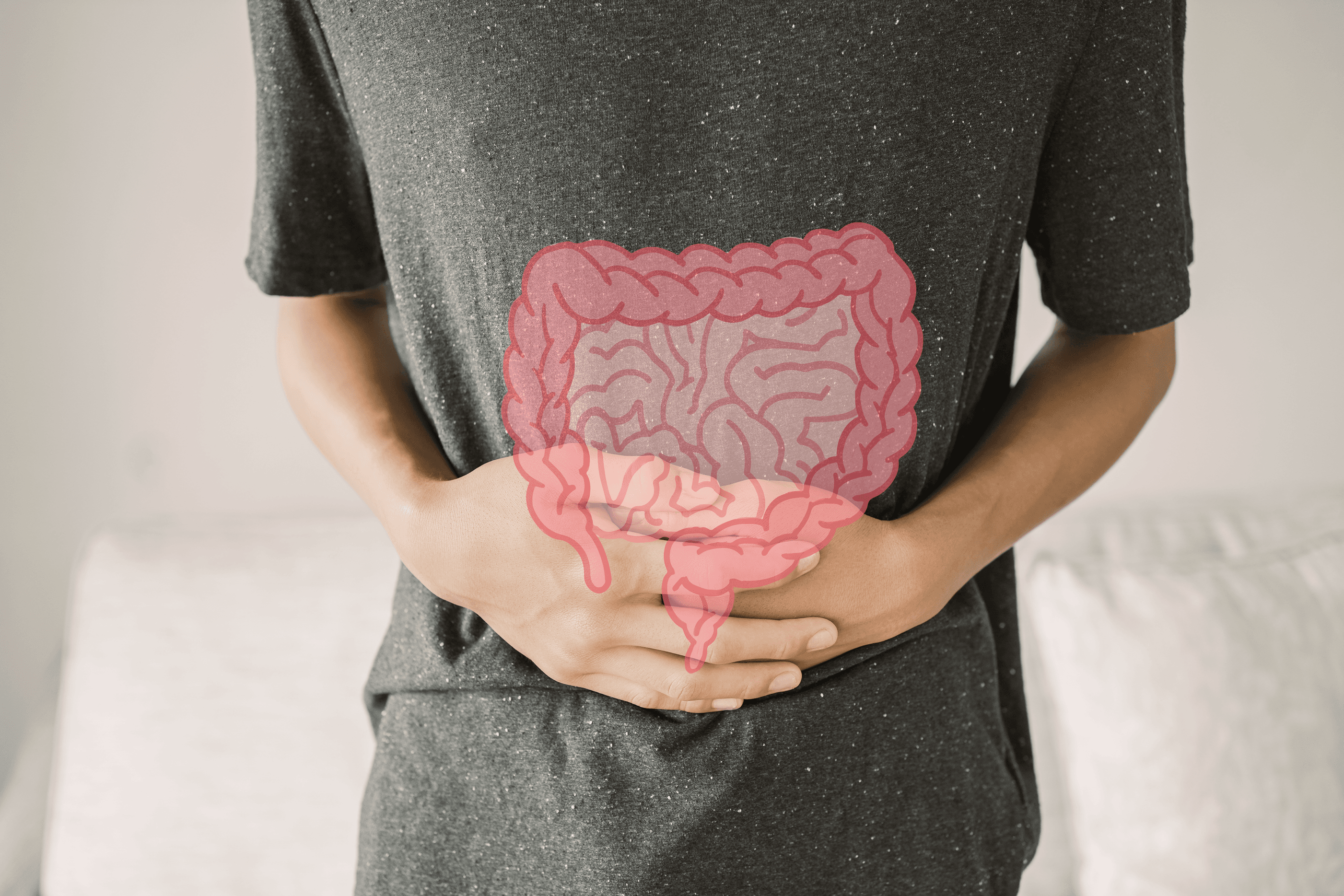 image of person clutching stomach with illustration of large intestine drawn on stomach