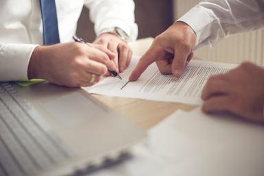 image depicting someone signing a contract